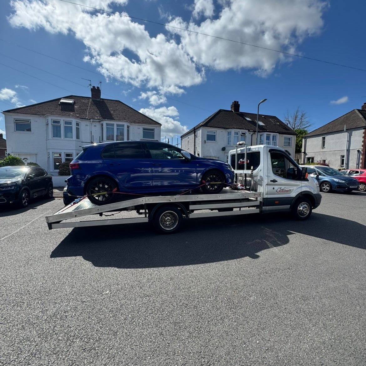 Blue Volkswagen Golf R on SR Recovery’s branded truck